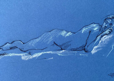 M-J Kelley's drawing of a woman reclining on the ground but propped up with a pillow. It is draw on textured blue Canson/Ingres paper with white and light blue hightlights. Draw in November 2002.