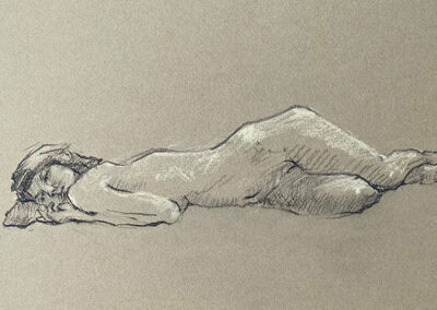 M-J Kelley's drawing of a woman reclining with a pillow on the ground. Charcoal on tan paper.